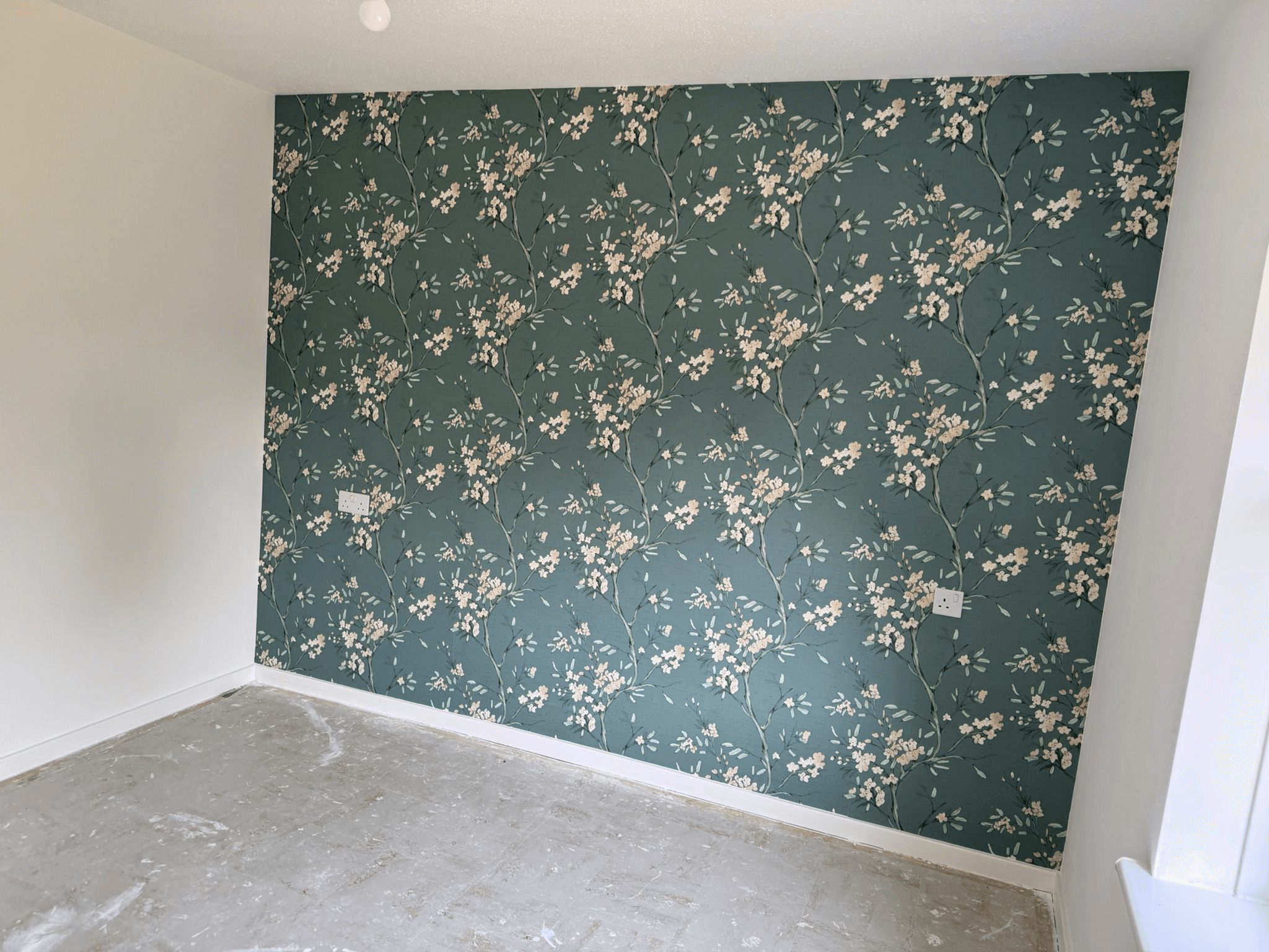 Dark green floral wallpaper feature wall