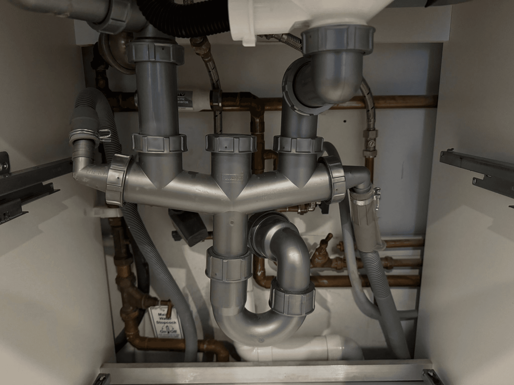 Complex under-sink pipework and copper pipes